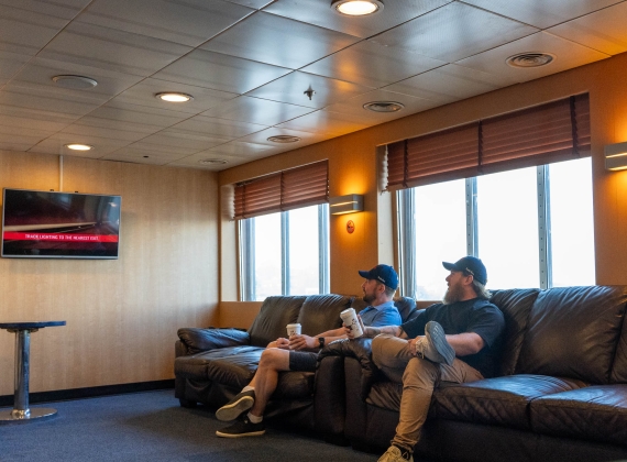Two commercial drivers relax in a lounge on the MV Fundy Rose