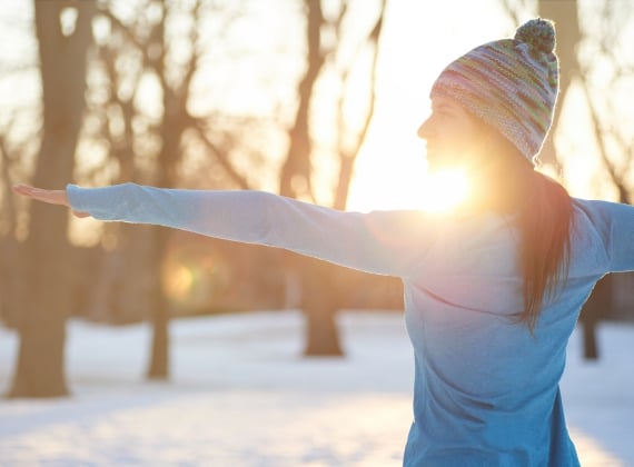 woman doing yoga in nature at winter - stock photo