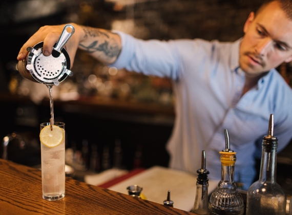 bartender-serving-drink-at-bar