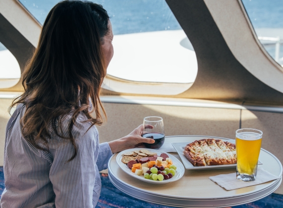 A person dining next to the window on the CAT ferry