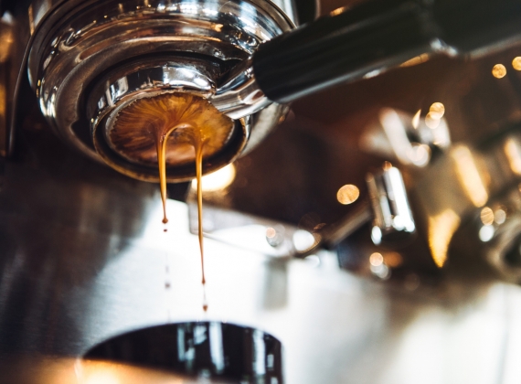 A shot of espresso being pulled by a machine