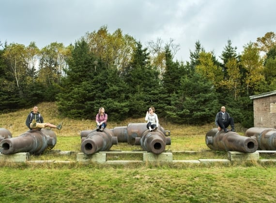 People sit on cannons at the battlements on McNabb's Island
