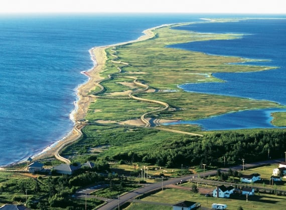 A winding road along a peninsula on the Acadian Coastal Drive