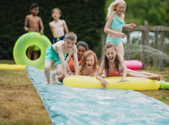 Kids Playing with a slip and slide