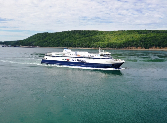 A ferry crossing the water close to land